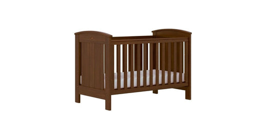 Brown baby cot with custom made sheets
